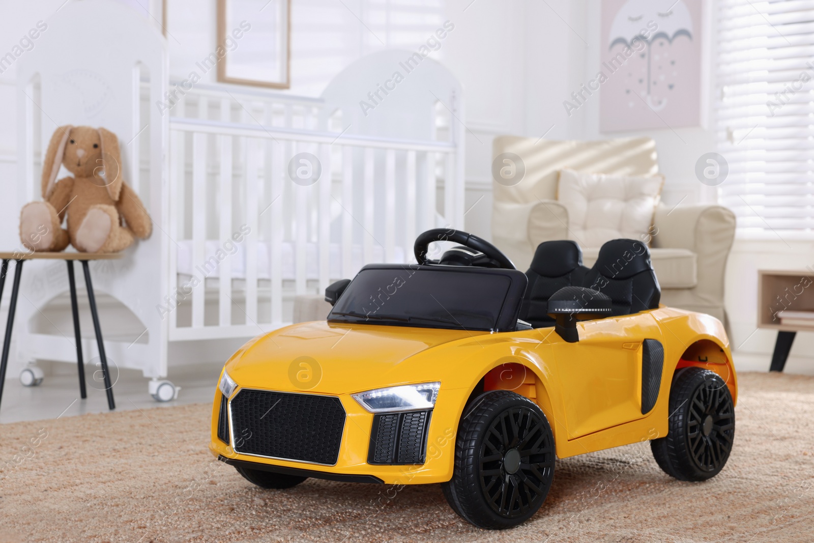 Photo of Yellow car in room at home. Child's toy