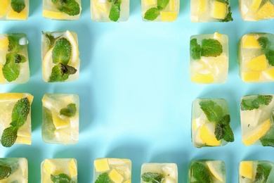 Flat lay composition with lemon and mint ice cubes on color background. Space for text