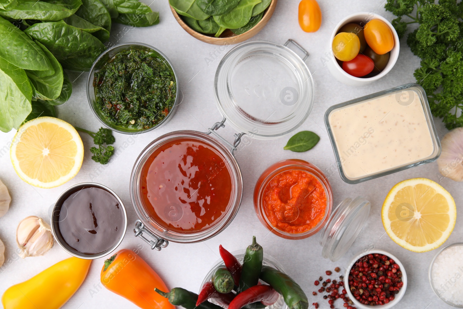 Photo of Different marinades and products on light table, flat lay