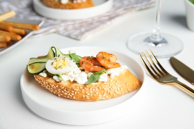 Photo of Plate of delicious bruschetta with shrimps on white table