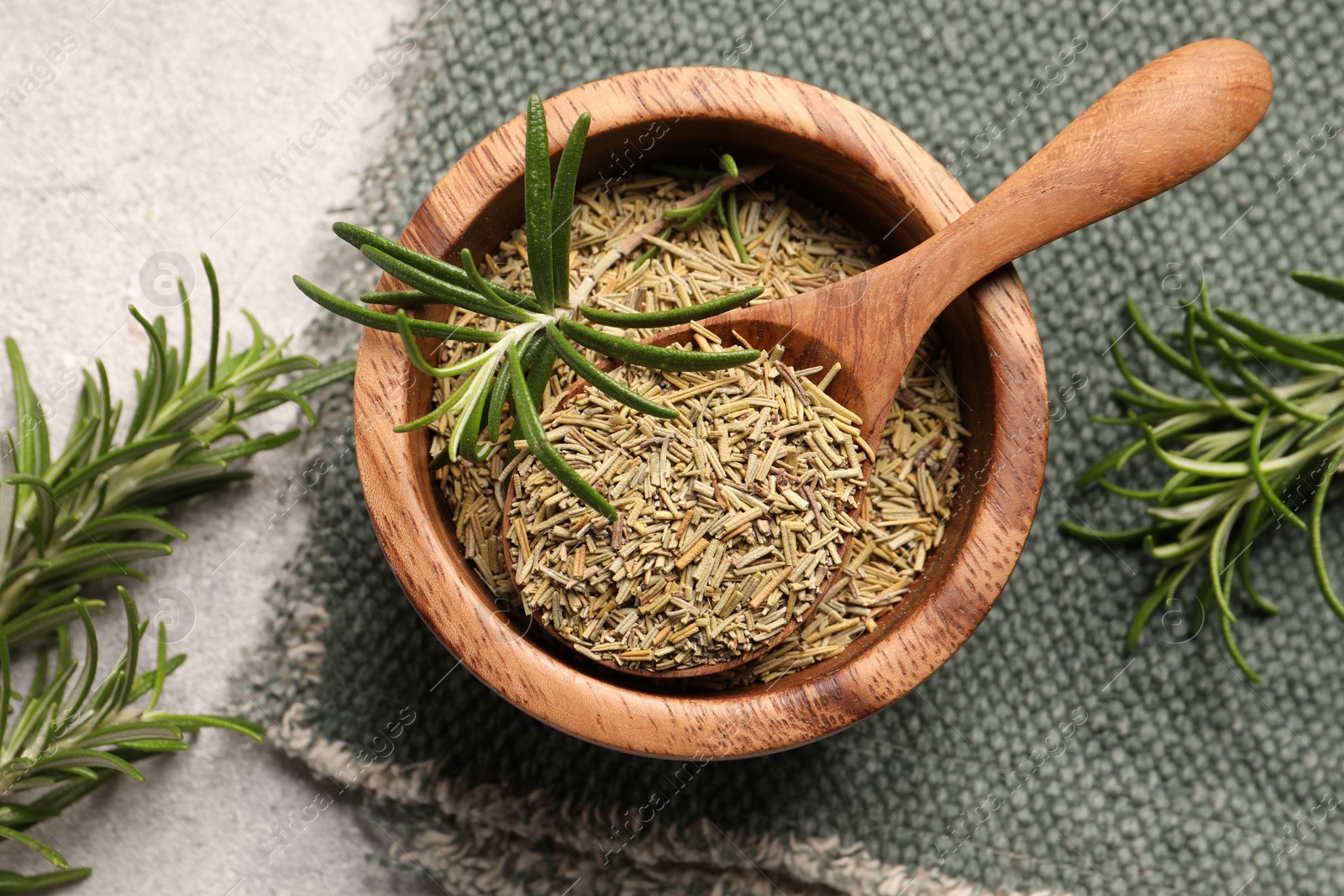 Photo of Fresh and dry rosemary on white textured table, flat lay