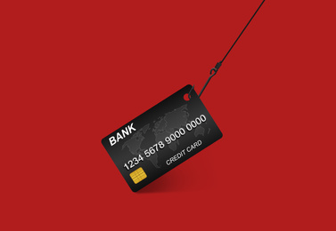 Image of Hook with credit card on red background. Cyber crime