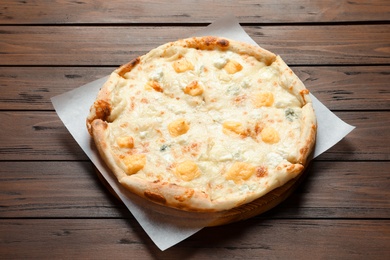 Photo of Hot cheese pizza Margherita on wooden table