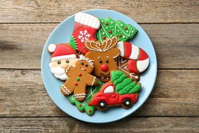 Different tasty Christmas cookies on wooden table, top view