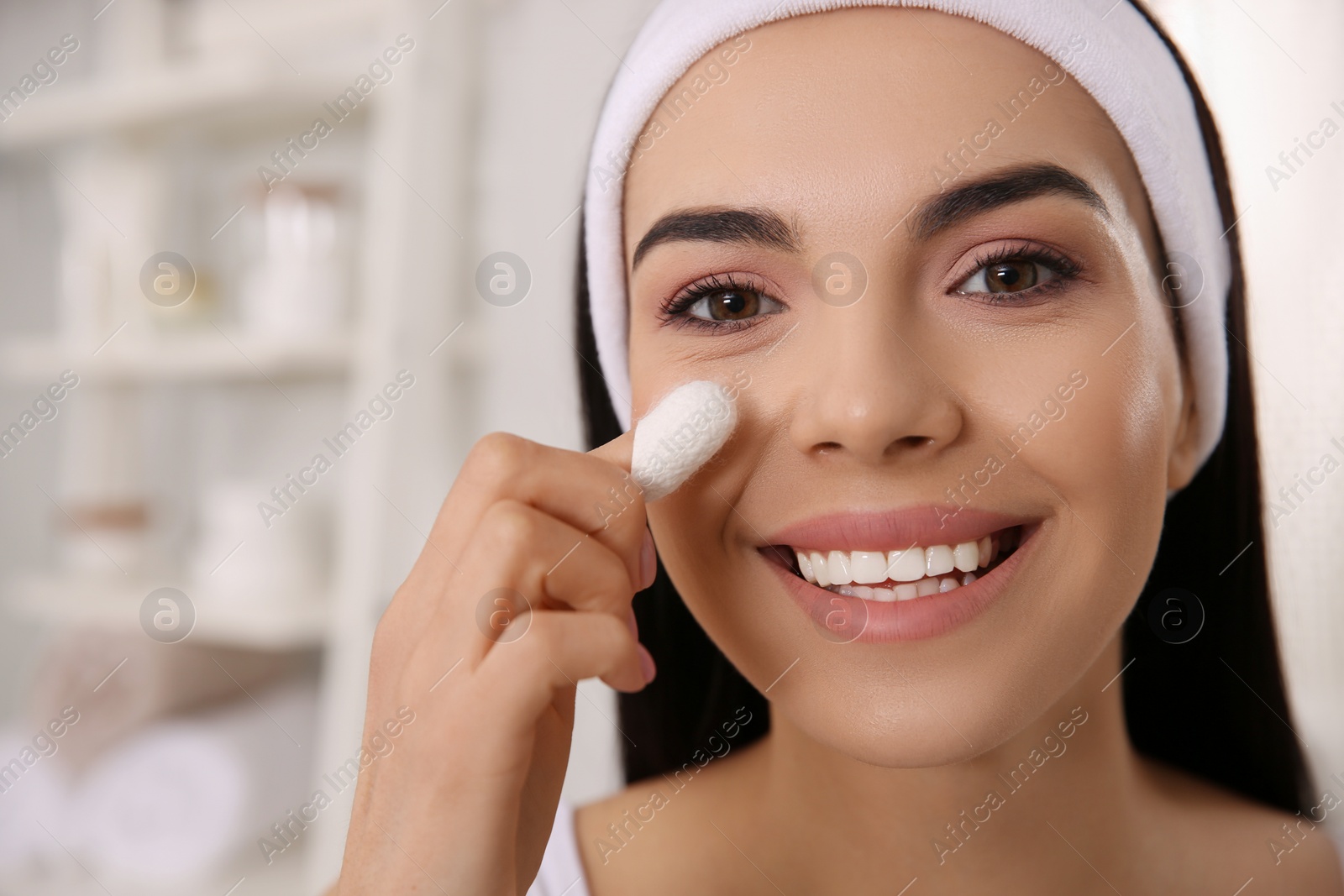 Photo of Woman using silkworm cocoon in skin care routine at home, closeup