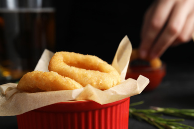 Fried onion rings served on black table in pub