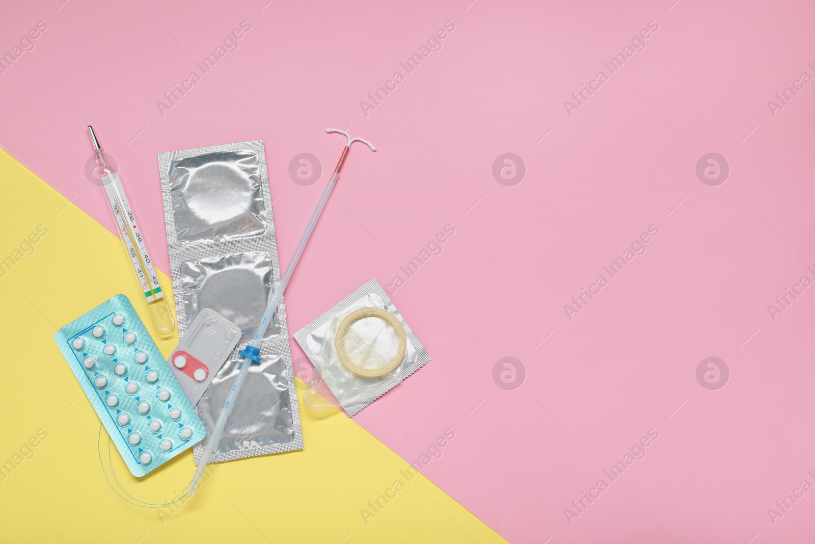 Photo of Contraceptive pills, condoms, intrauterine device and thermometer on color background, flat lay with space for text. Choice of birth control method