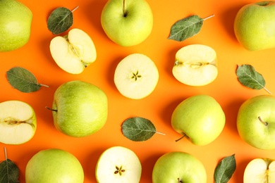 Photo of Flat lay composition of fresh ripe green apples on orange background