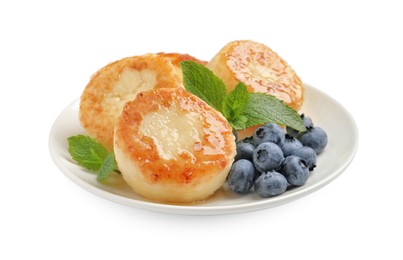 Delicious cottage cheese pancakes with blueberries, honey and mint on white background