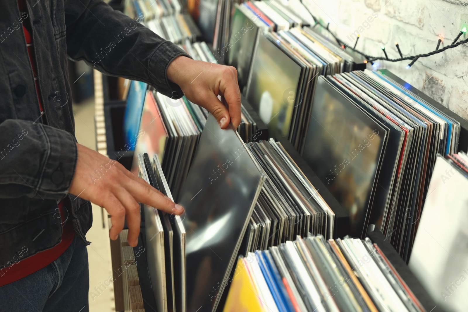 Image of Man choosing vinyl records in store, closeup