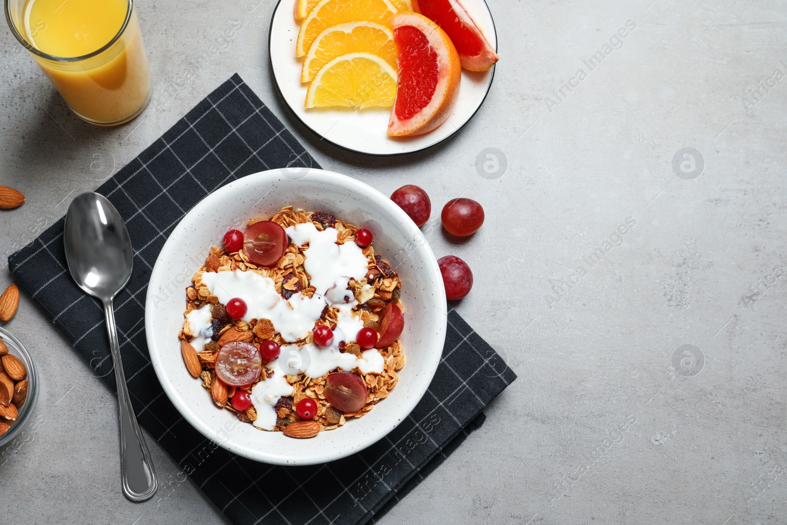 Photo of Tasty healthy breakfast served on grey table, flat lay. Space for text