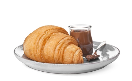 Tasty croissant with chocolate on plate against white background