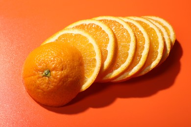 Slices of juicy orange on terracotta background