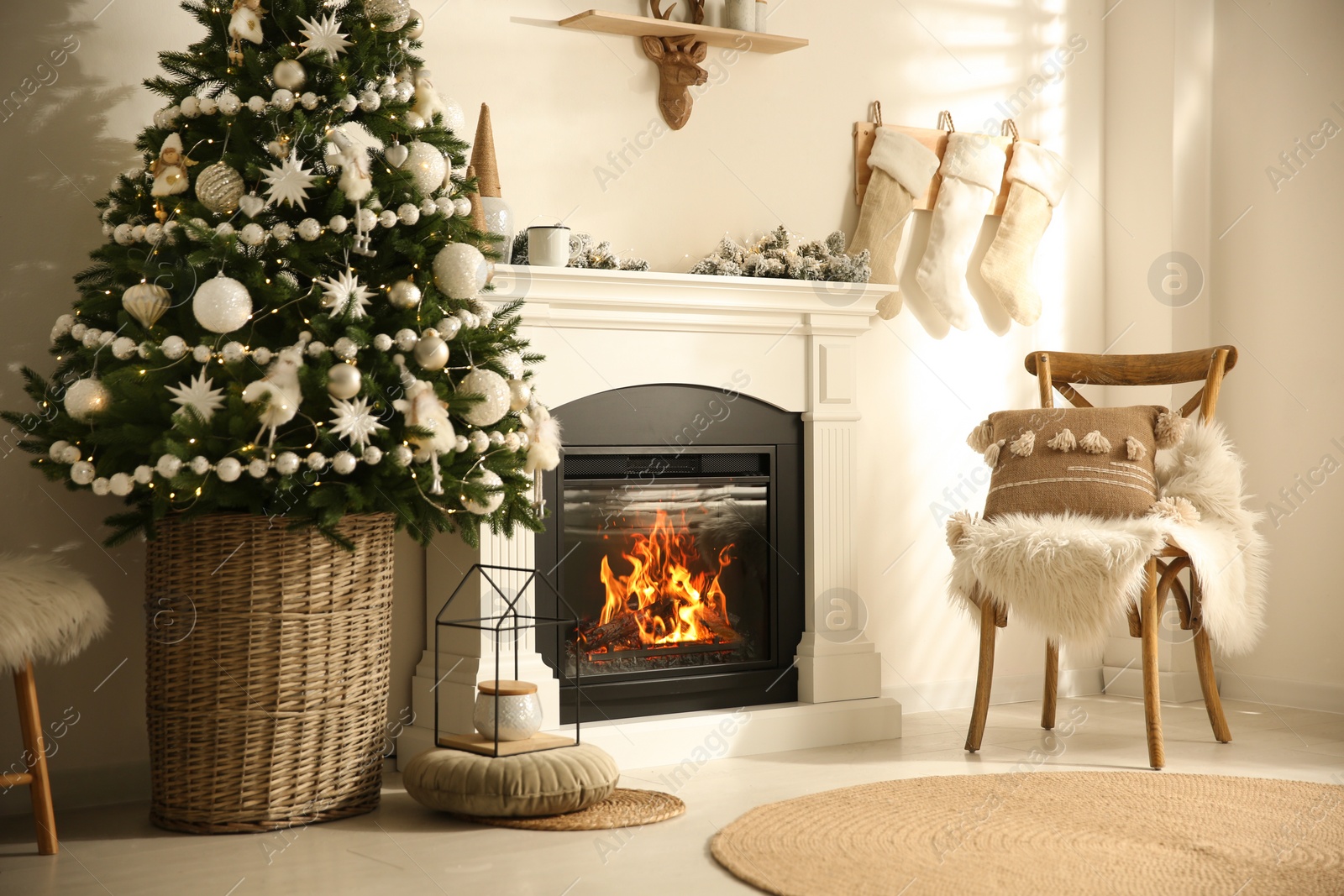 Photo of Beautiful living room interior with decorated Christmas tree and modern fireplace