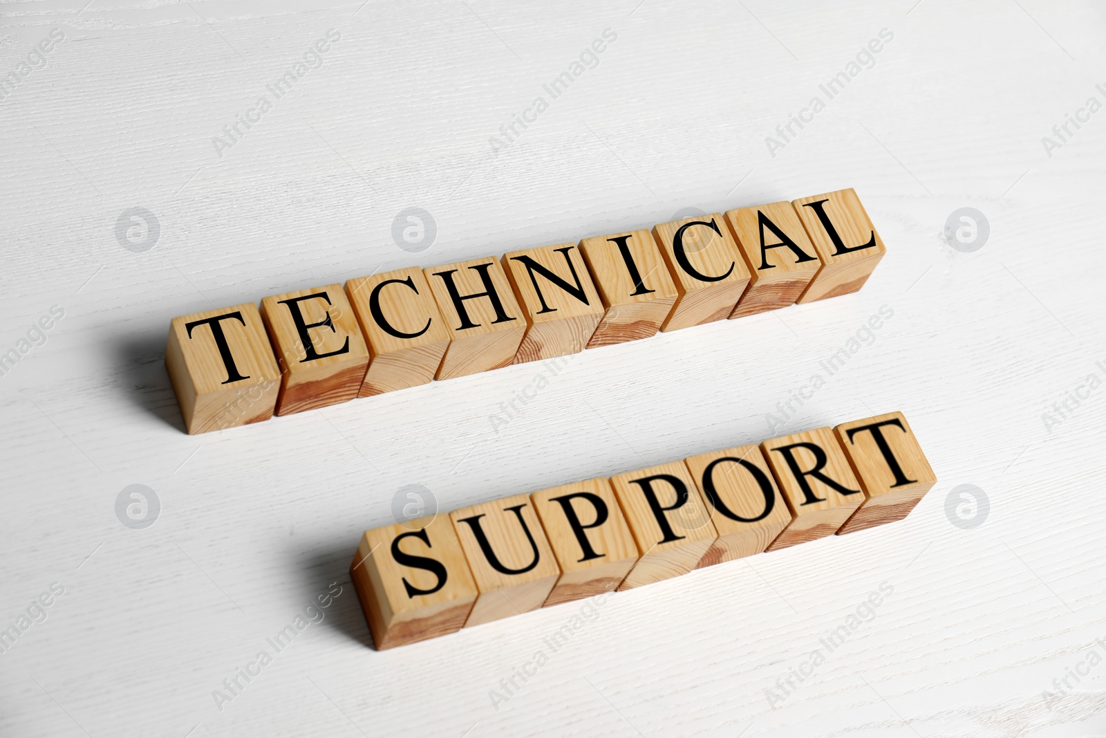 Photo of Cubes with words TECHNICAL SUPPORT on wooden background