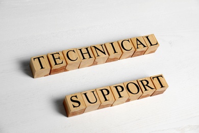 Photo of Cubes with words TECHNICAL SUPPORT on wooden background