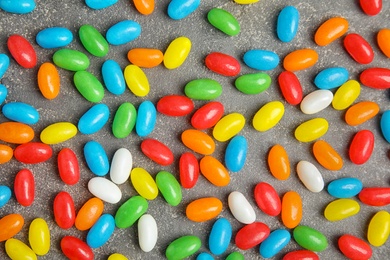 Flat lay composition with jelly beans on stone background