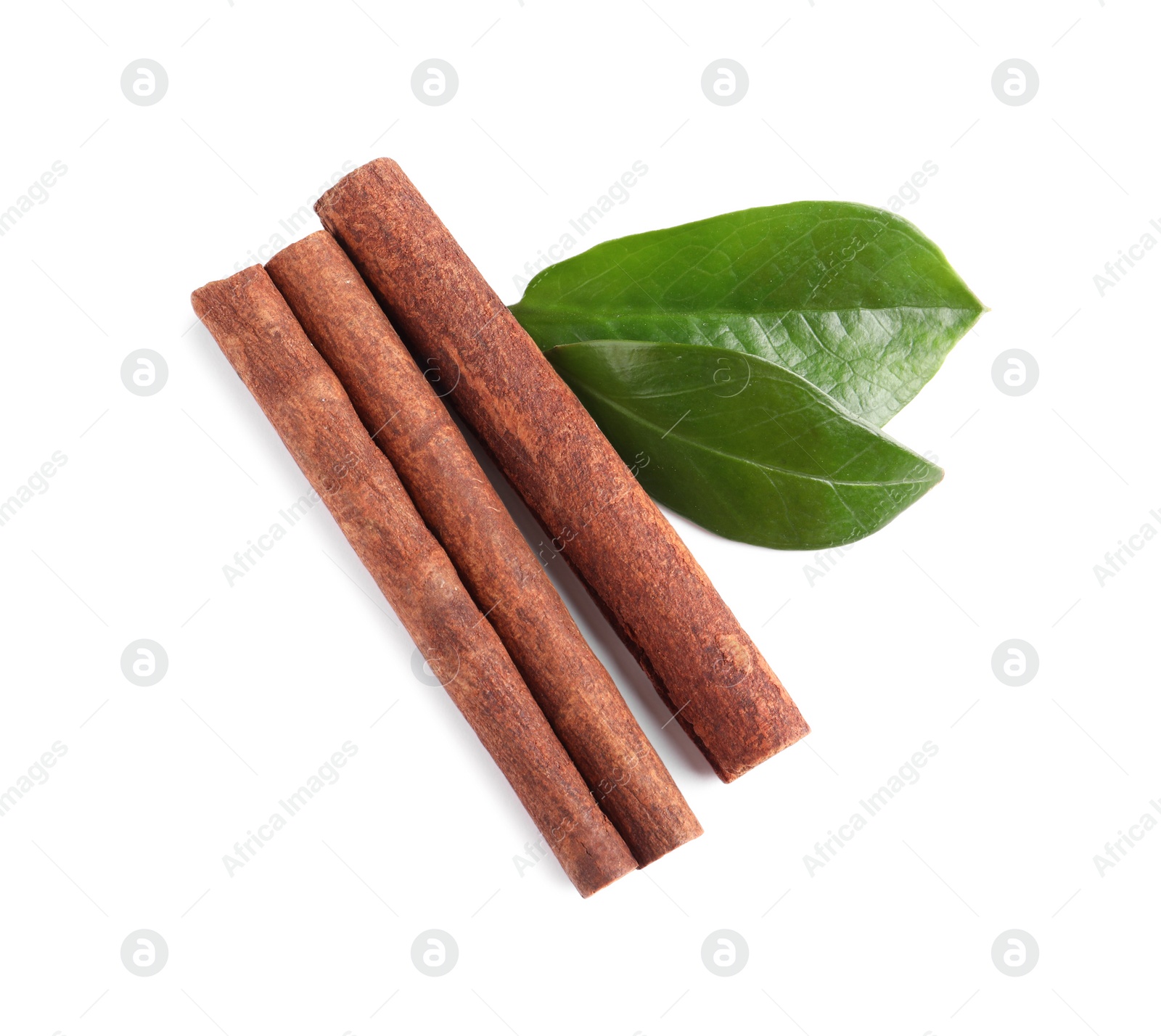 Photo of Cinnamon sticks and green leaves isolated on white, top view