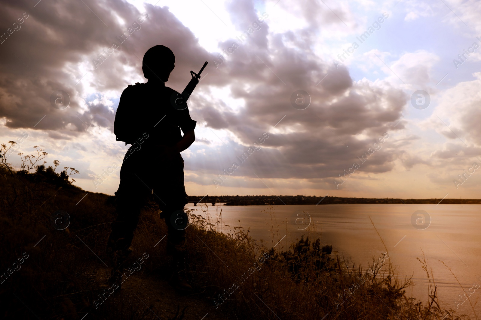 Photo of Soldier with machine gun patrolling outdoors. Military service