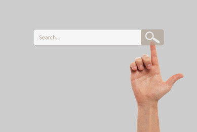 Image of Man using search bar on virtual screen, closeup