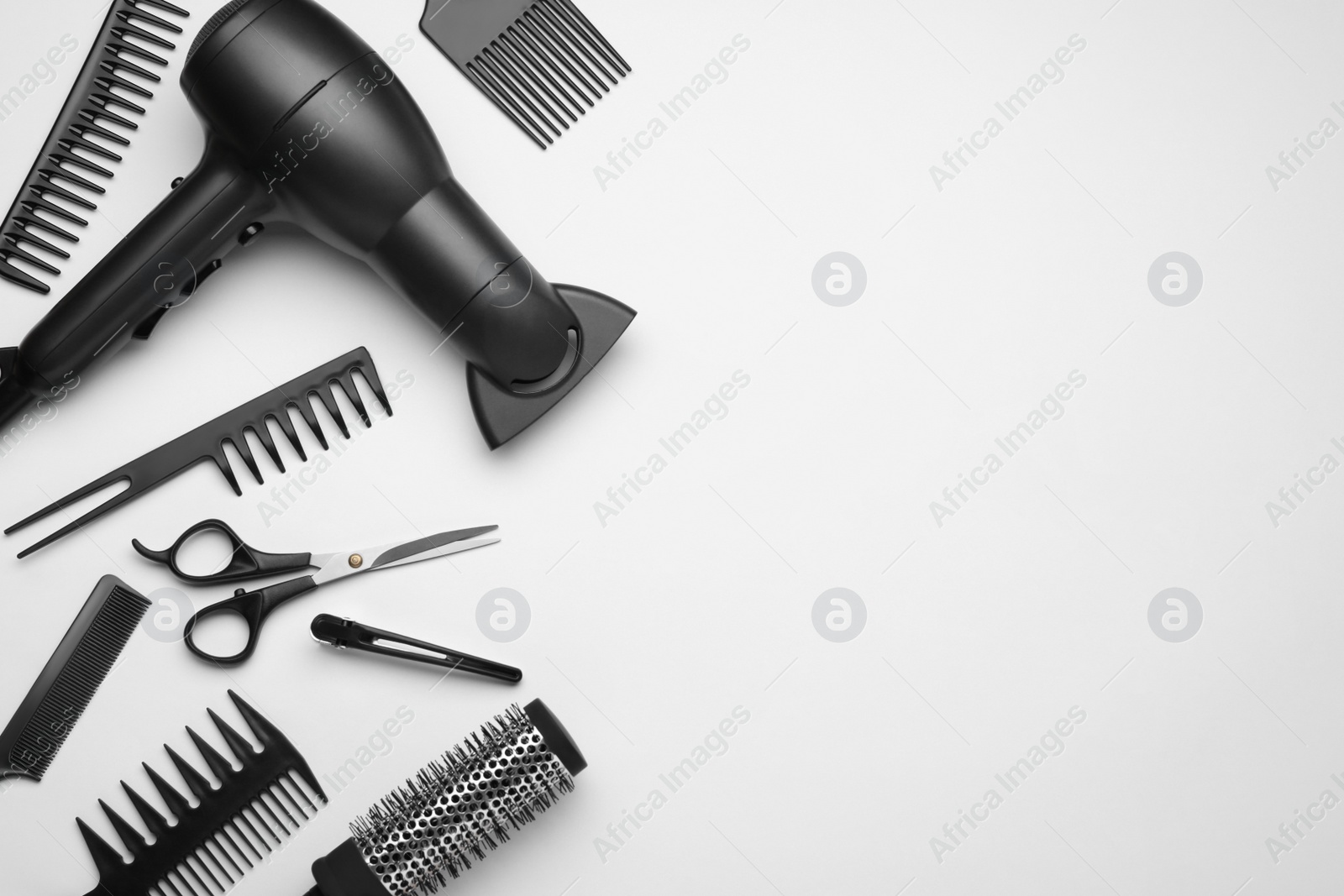 Photo of Flat lay composition with modern hair dryer on white background, space for text