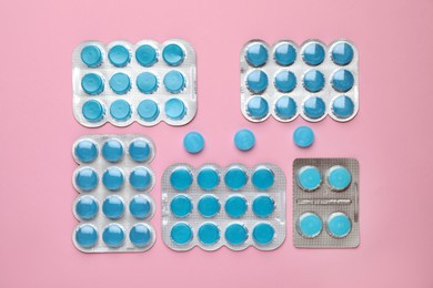 Photo of Blue cough drops on pink background, flat lay