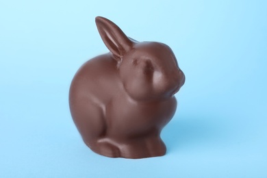 Photo of Chocolate bunny on light blue background. Easter celebration