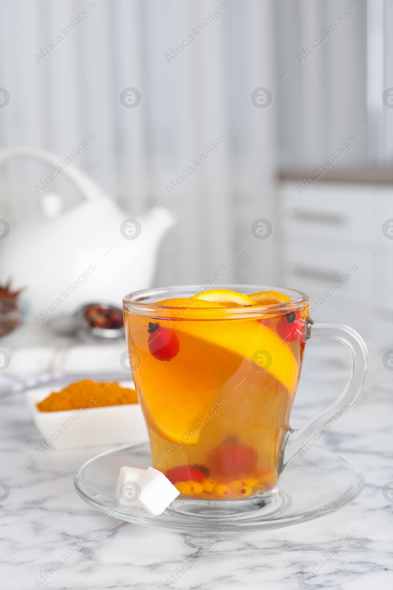 Photo of Immunity boosting drink on white marble table indoors