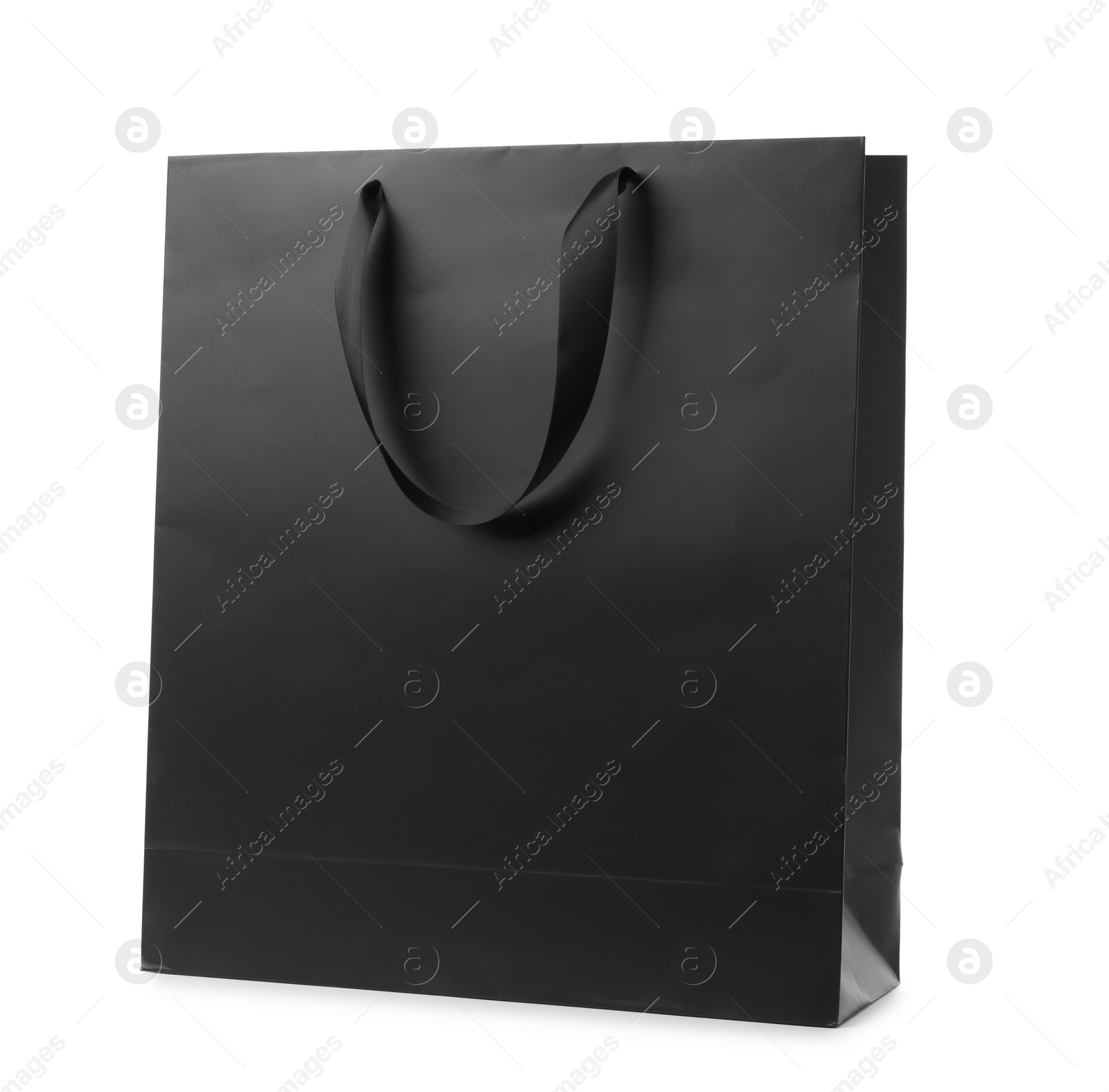 Photo of Paper shopping bag with ribbon handles on white background. Mockup for design