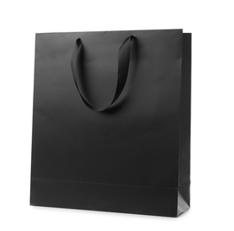 Photo of Paper shopping bag with ribbon handles on white background. Mockup for design