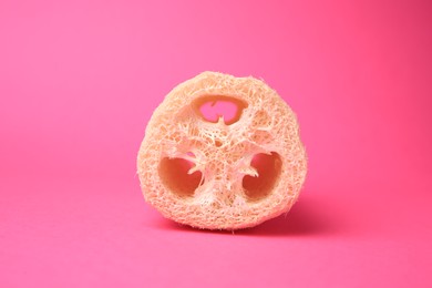 Photo of Natural loofah sponge on pink background. Personal hygiene