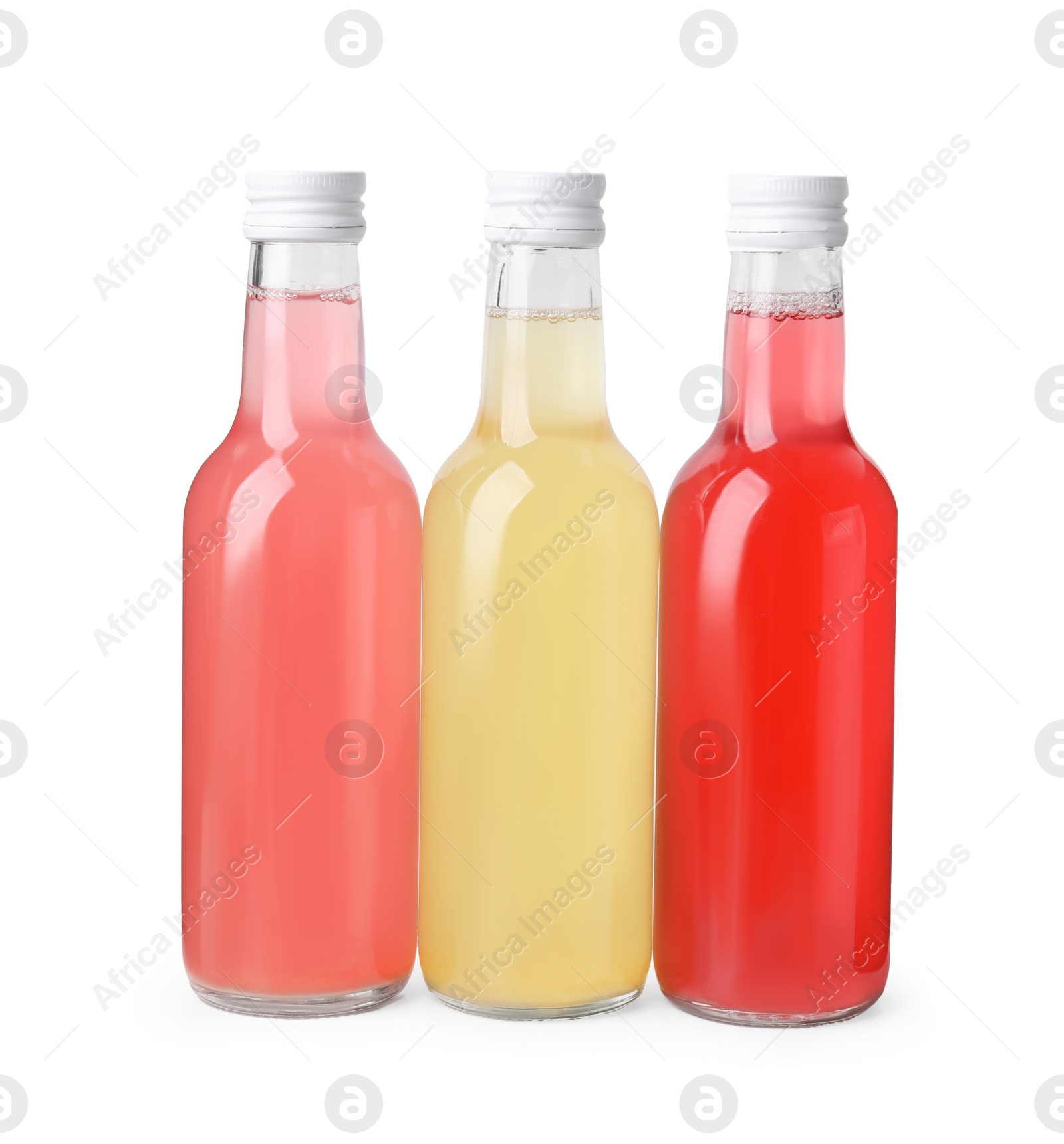 Photo of Delicious kombucha in glass bottles isolated on white