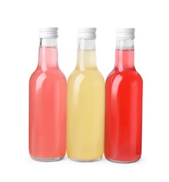 Photo of Delicious kombucha in glass bottles isolated on white