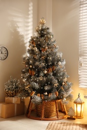 Photo of Beautiful decorated Christmas tree in festive room interior
