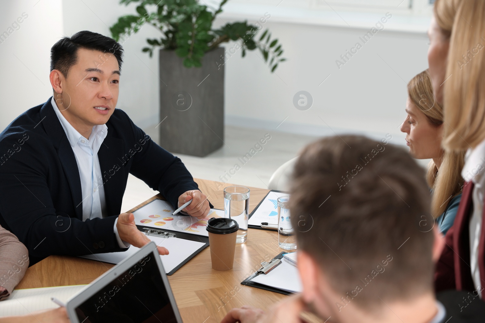 Photo of Businesspeople having meeting at table in office