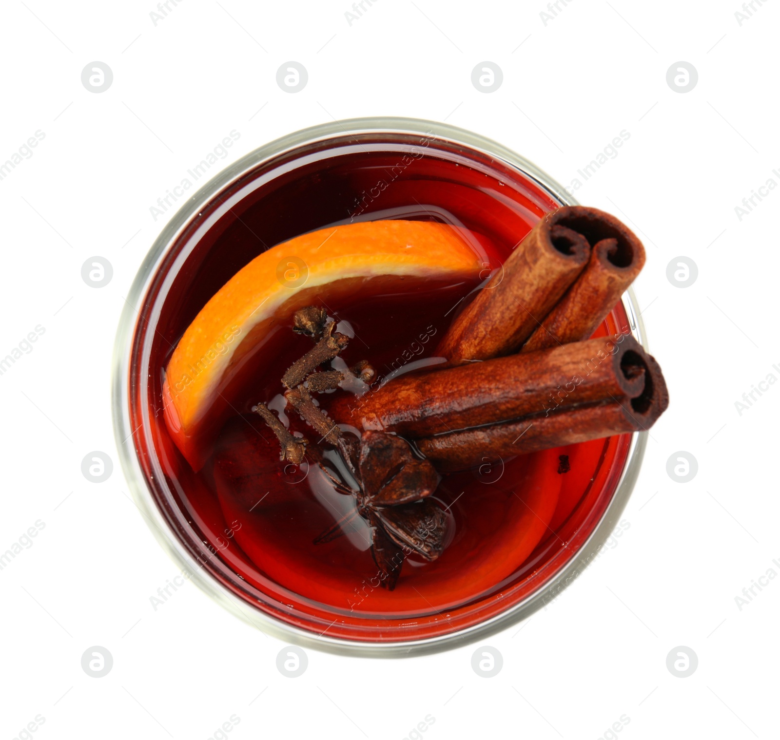 Photo of Glass of mulled wine with spices isolated on white, top view