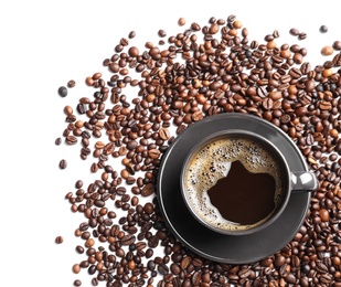 Photo of Roasted coffee beans and cup of hot beverage on white background, top view