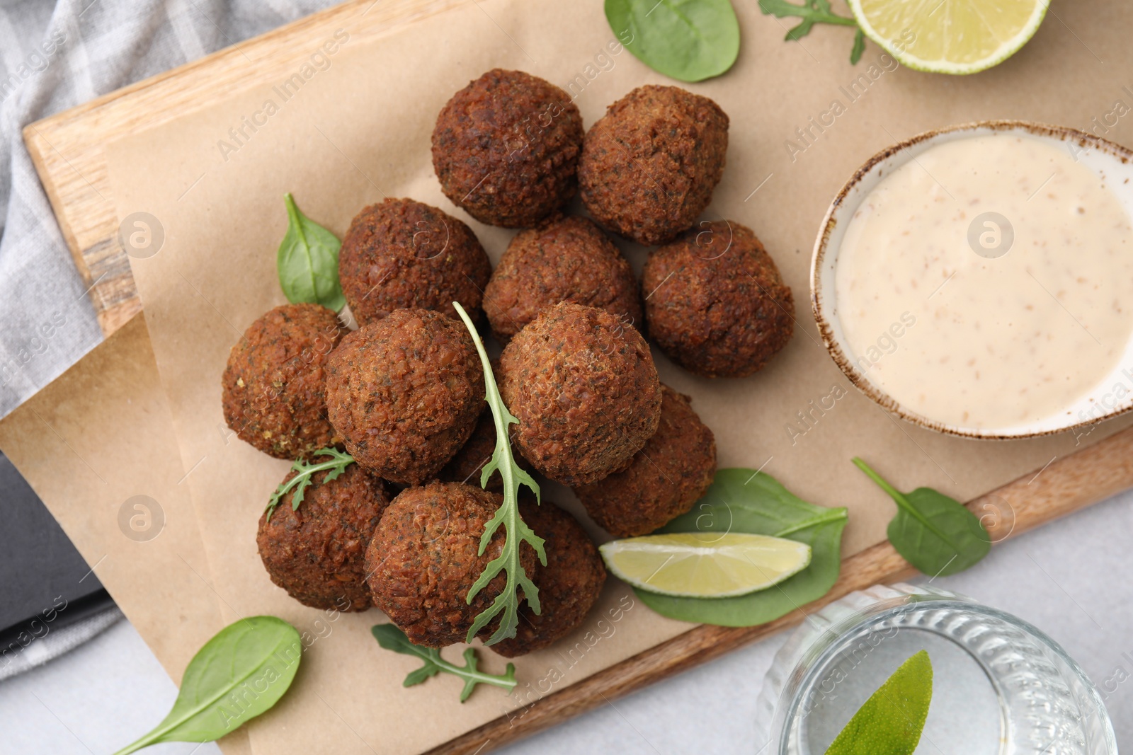 Photo of Delicious falafel balls served on light table, top view