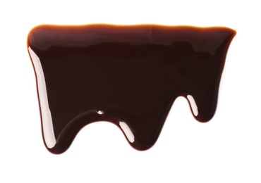Photo of Flowing chocolate sauce on white background