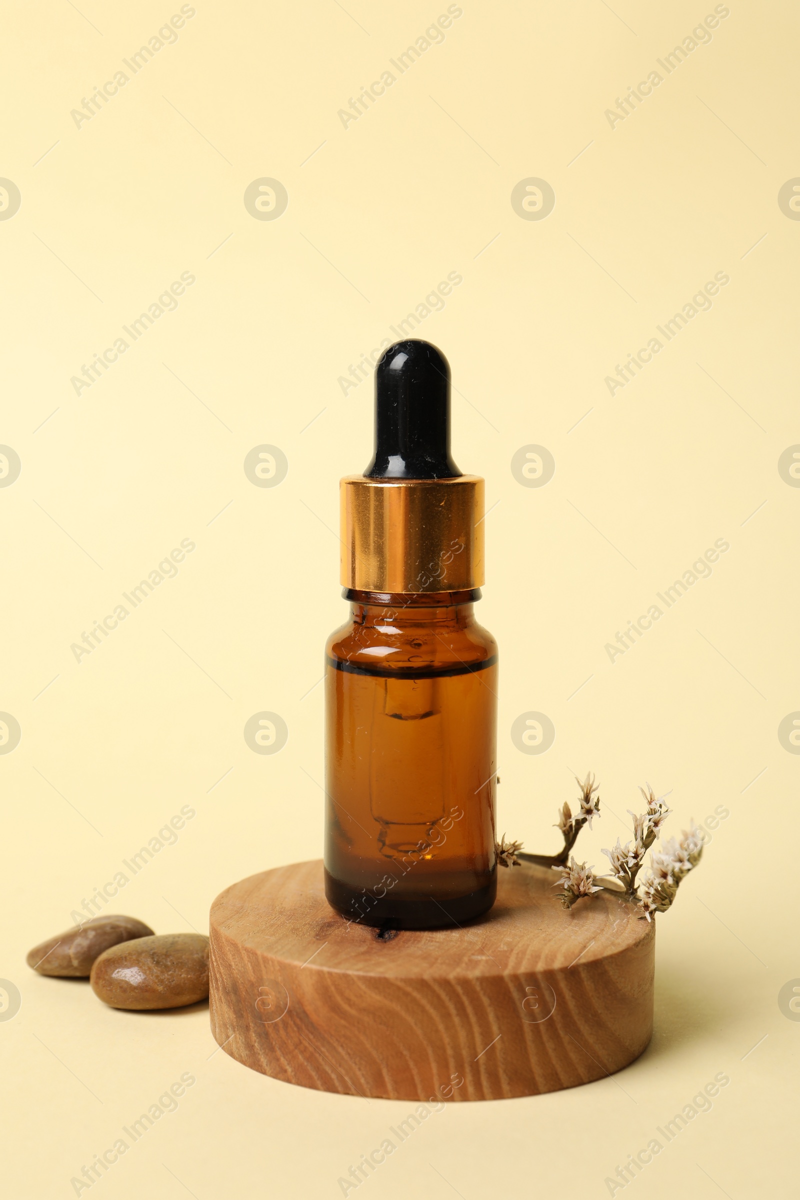 Photo of Composition with bottle of cosmetic serum on beige background