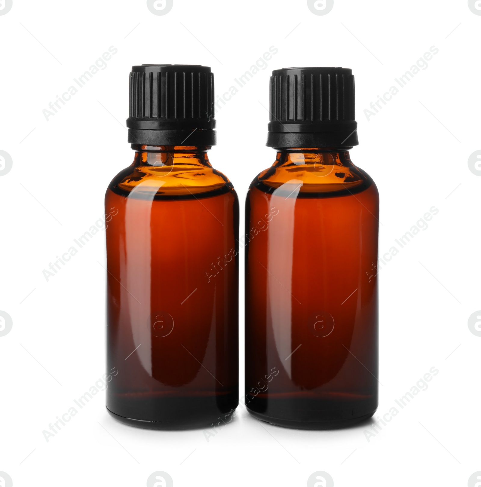 Photo of Bottles of essential oil isolated on white