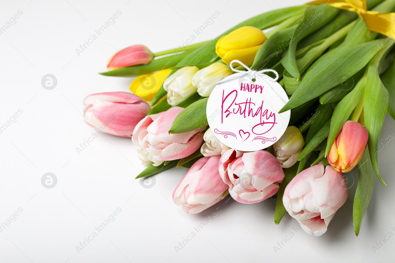 Image of Beautiful bouquet of tulip flowers with Happy Birthday card on white background