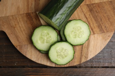 Fresh cut cucumber on wooden table, top view