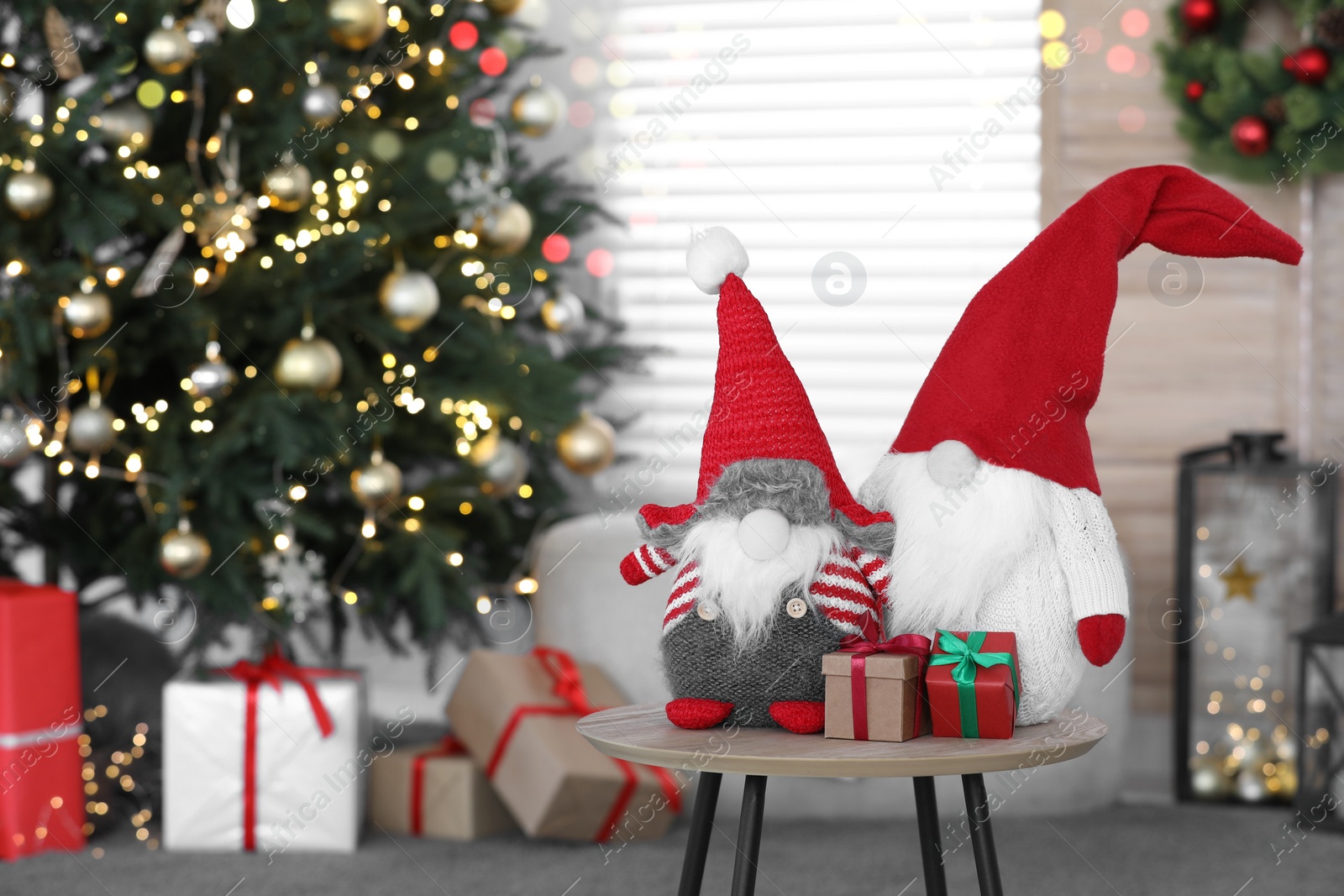 Photo of Cute Scandinavian gnomes and Christmas gift boxes in room