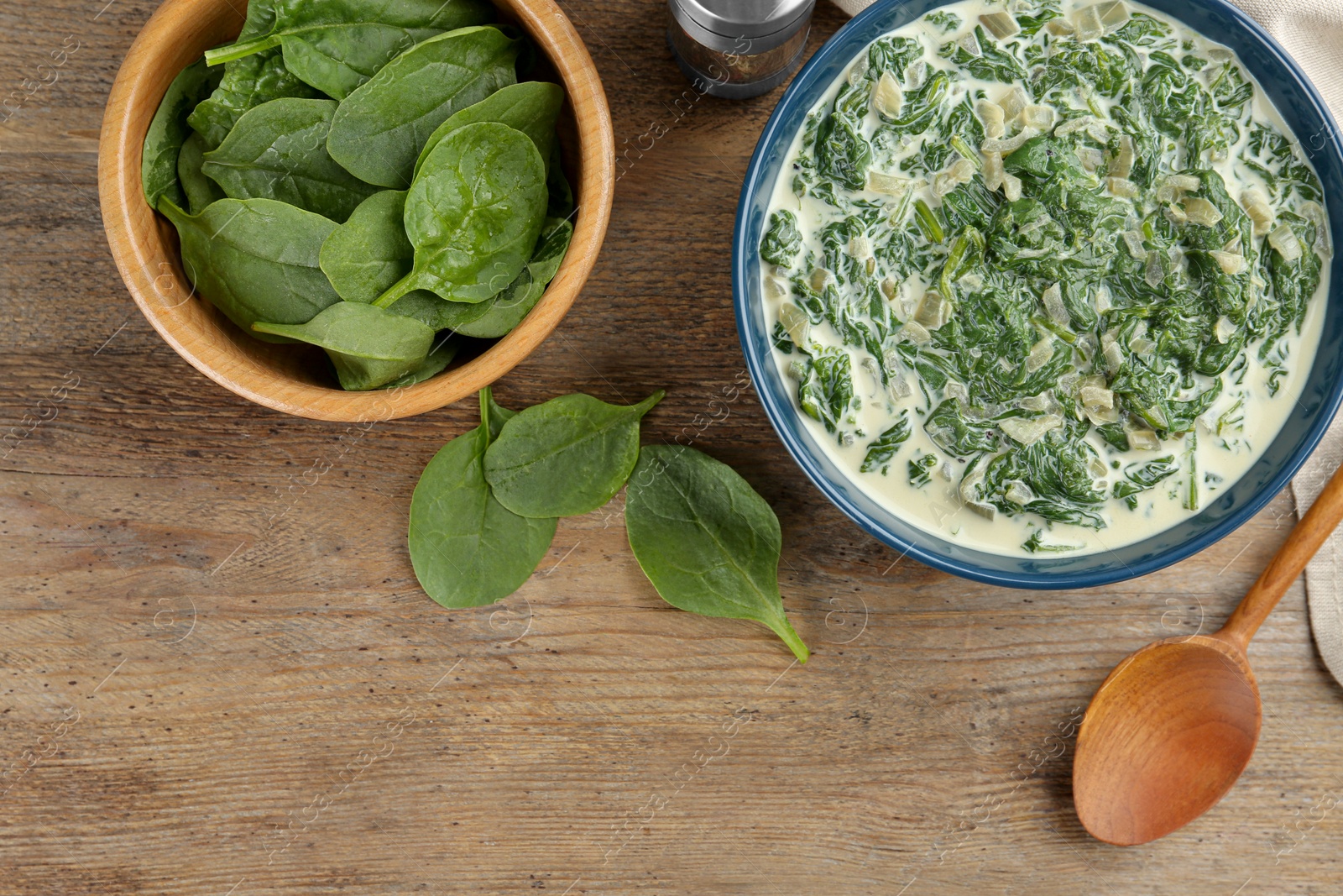 Photo of Tasty spinach dip on wooden table, flat lay