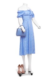 Photo of Female mannequin with accessories dressed in stylish light blue dress isolated on white