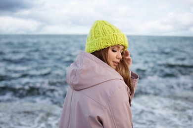 Portrait of beautiful young woman near sea