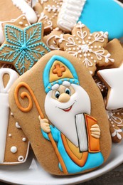 Photo of Tasty gingerbread cookies on plate, closeup. St. Nicholas Day celebration