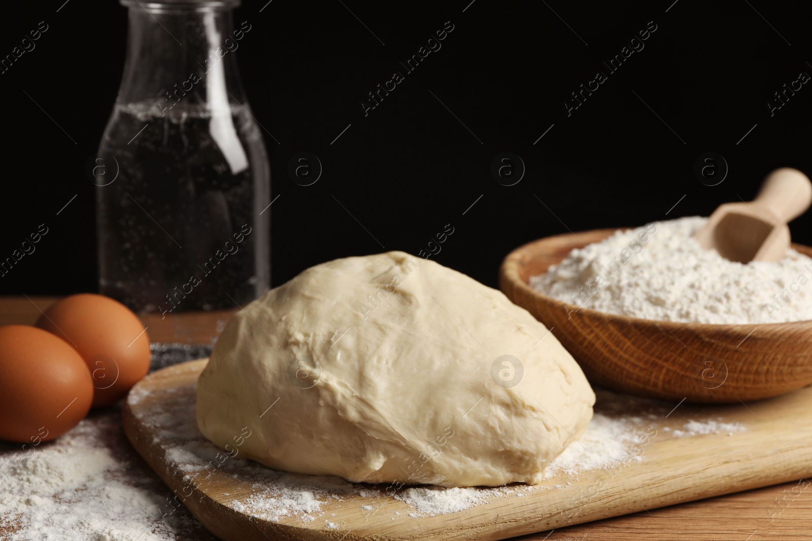 Photo of Cooking scones with soda water. Dough and ingredients on wooden table, closeup