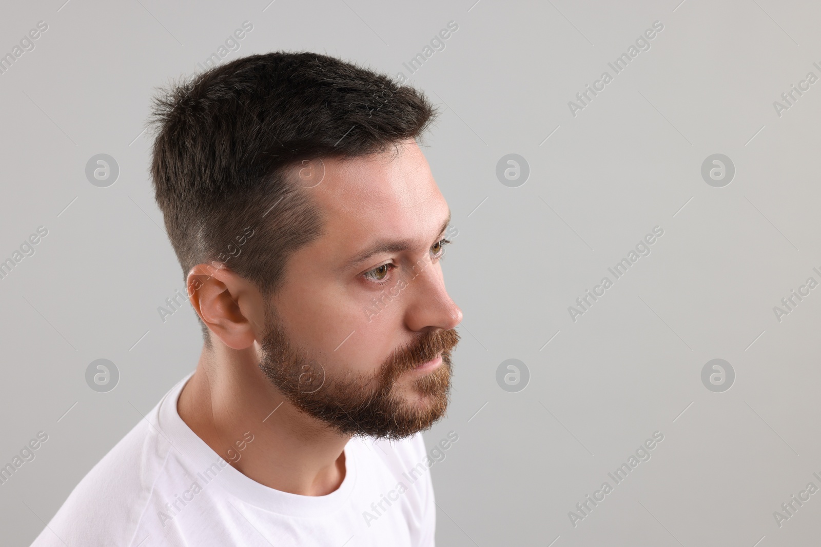 Photo of Man with healthy hair on grey background. Space for text